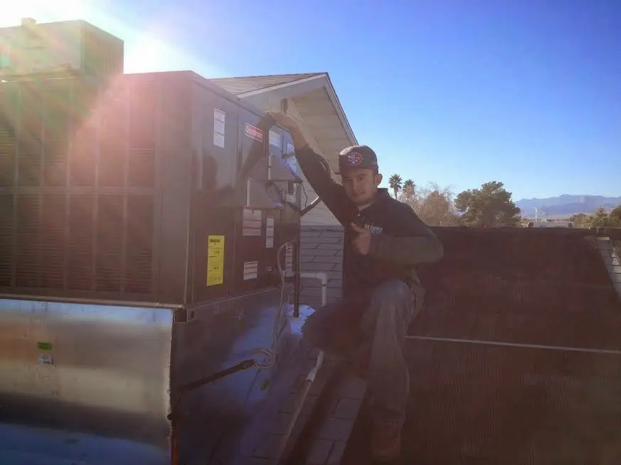 HVAC technician performing AC Tune-Up on a rooftop unit in Gardner